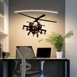 Black helicopter wall sticker above a modern workspace with a sleek chair and plant.