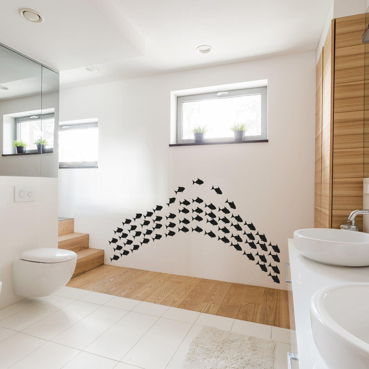 Stylish fish vinyl wall sticker set showcasing a playful design in a modern bathroom setting.
