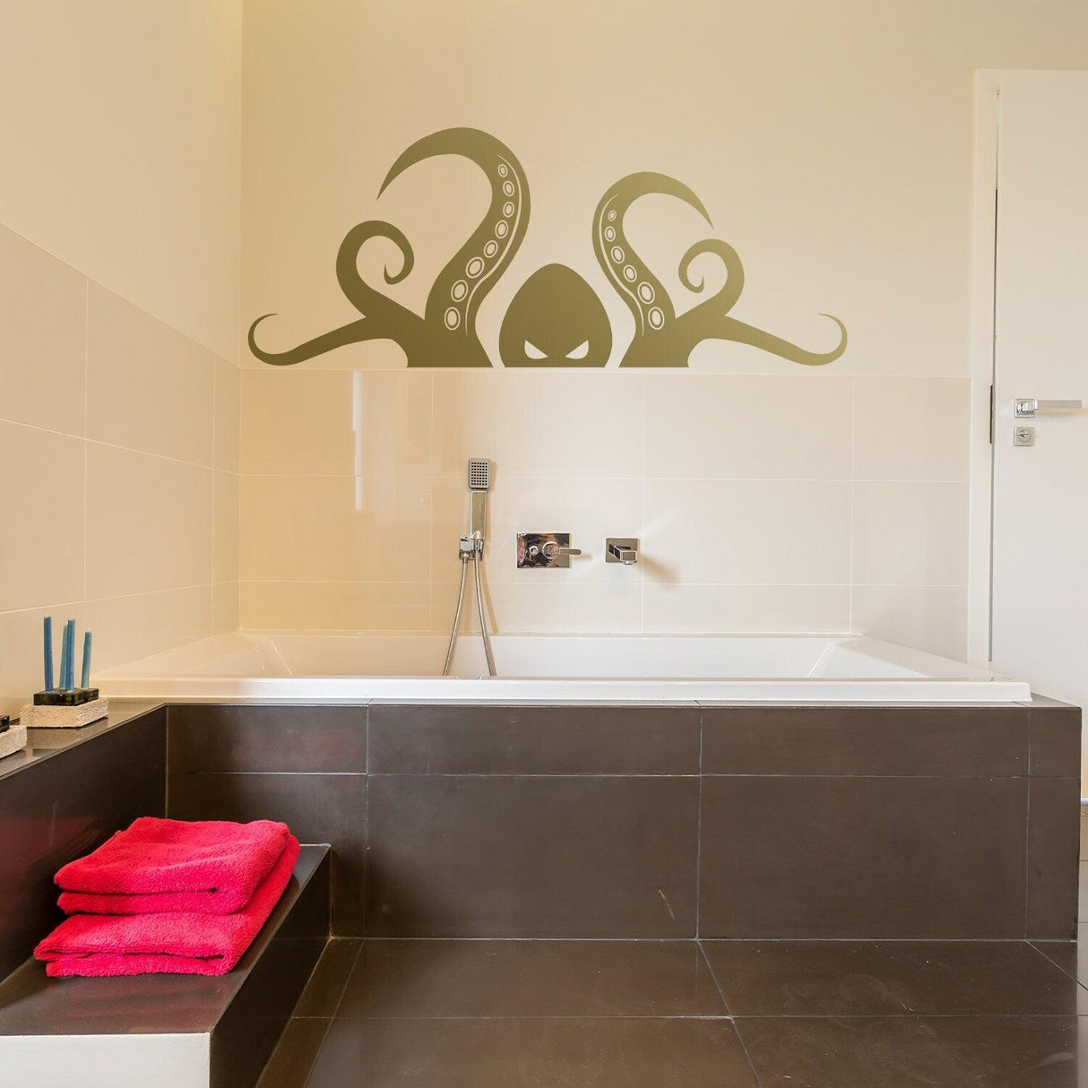 Octopus tentacle vinyl wall art sticker above a bathtub, adding ocean-themed decor to a bathroom.