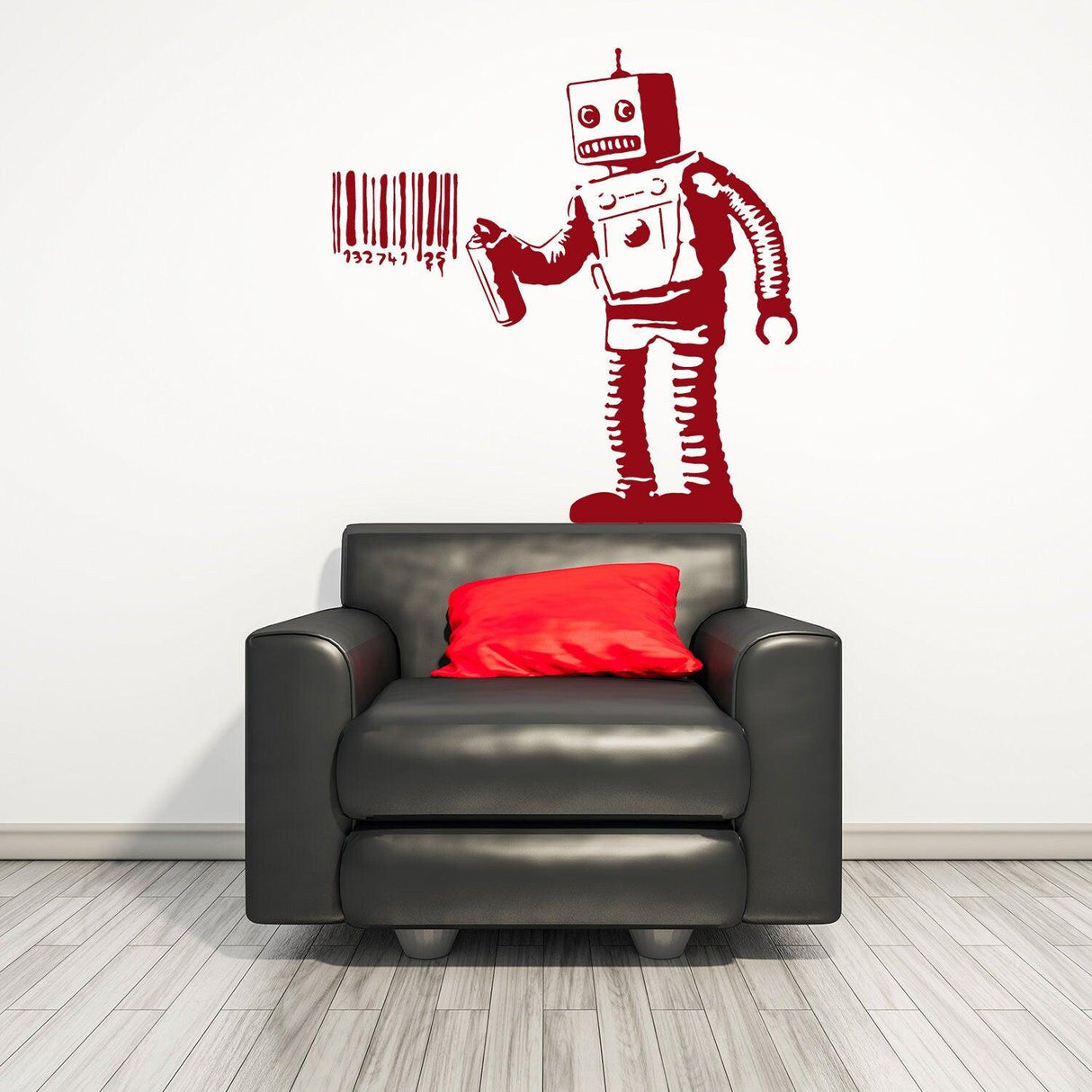 Banksy Barcode Robot Wall Vinyl Sticker above a black armchair with red cushions, showcasing urban street art decor.