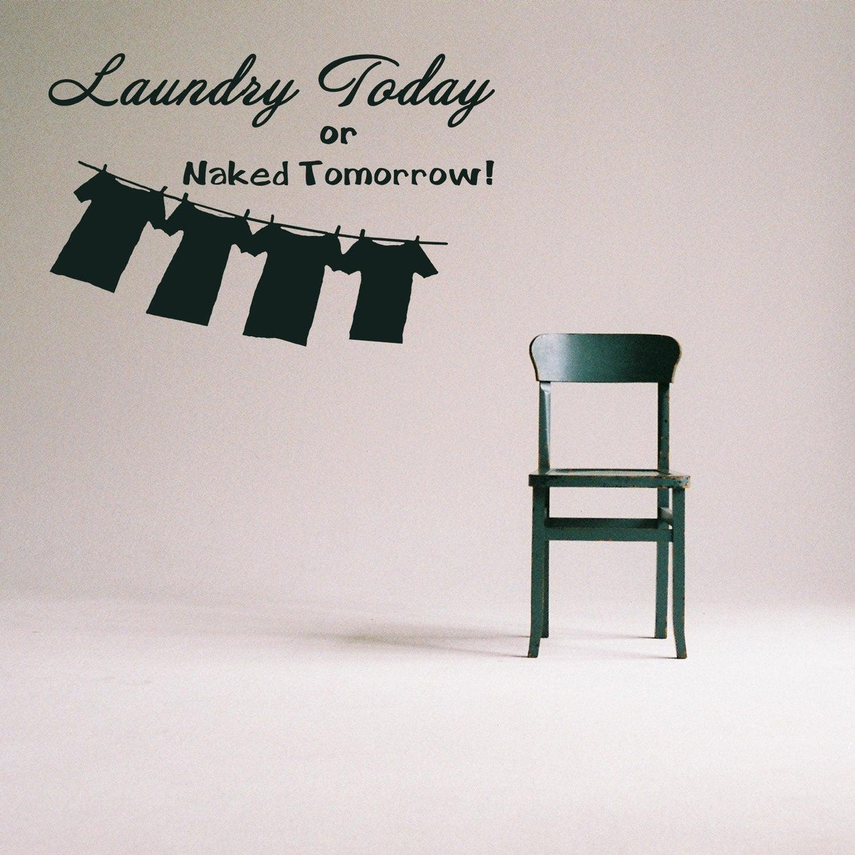 Laundry quote wall vinyl sticker with clothing on a line above a green chair, perfect for home decor.