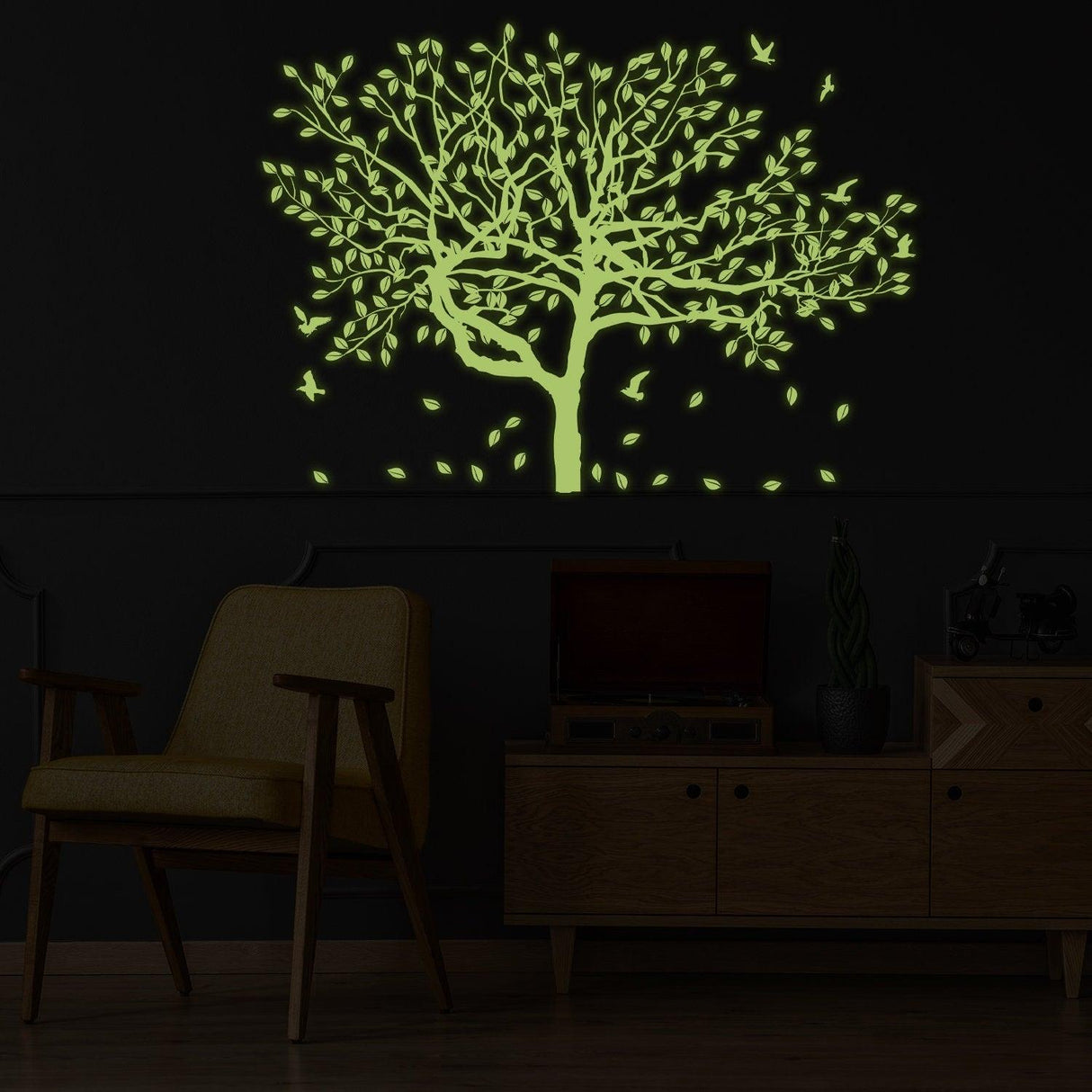 Glow in the dark tree vinyl wall sticker art illuminating a dark room, perfect for kids' room decor.