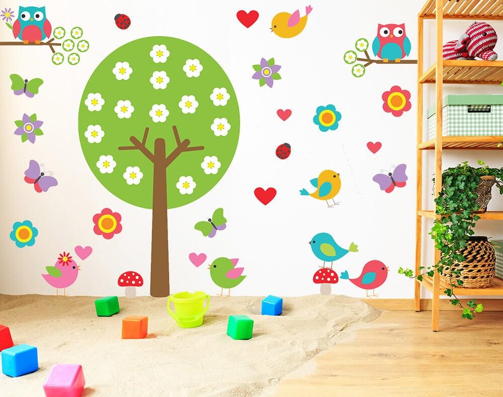 Colorful nursery vinyl wall decal featuring a tree, birds, and flowers, perfect for kids' rooms.