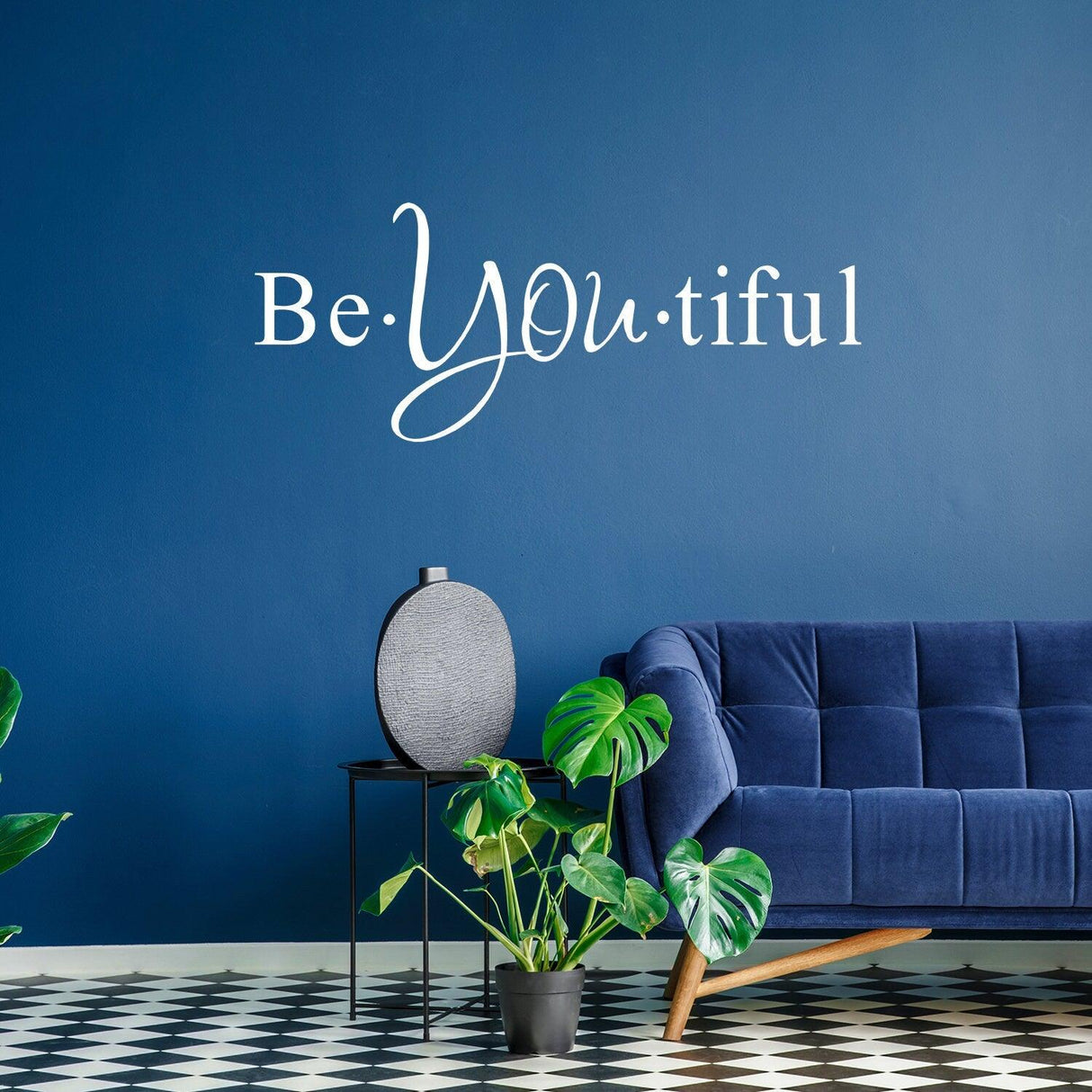 Be You tiful wall sticker on blue wall with plants and modern furniture, adding inspiration to home décor.
