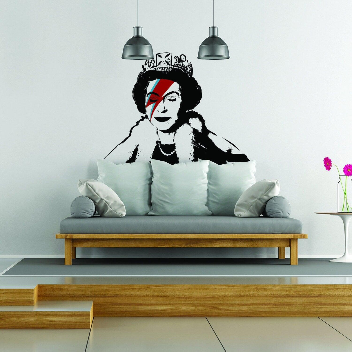 Banksy Queen vinyl sticker on a living room wall with a modern couch and decorative pillows.