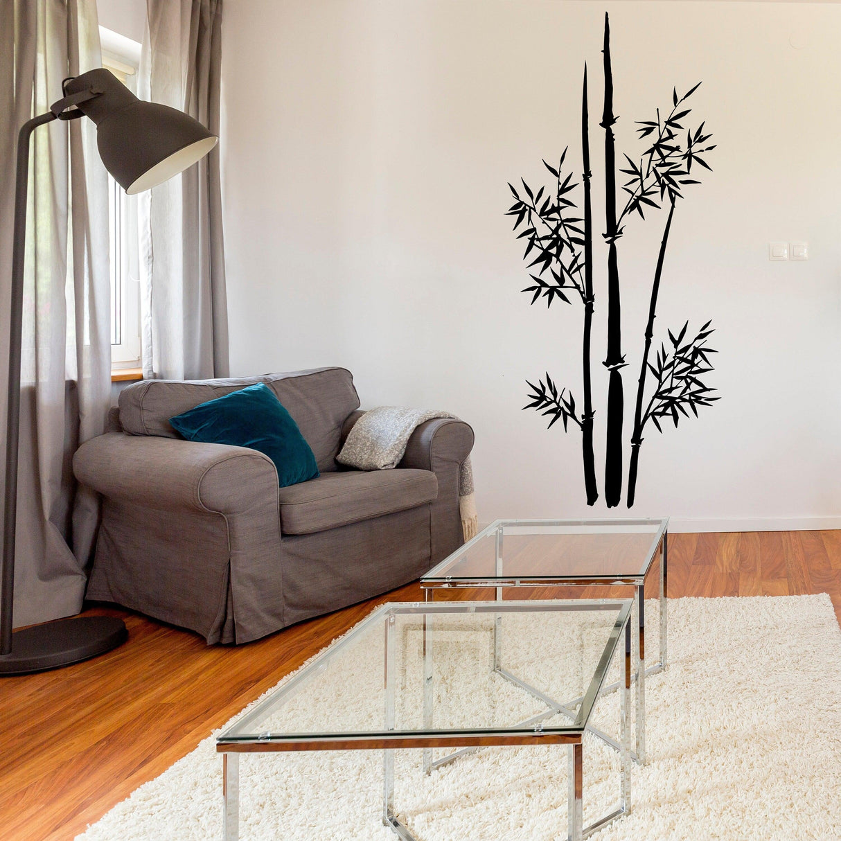 Bamboo wall vinyl sticker decal showcased in a stylish living room decor with a couch and glass table.
