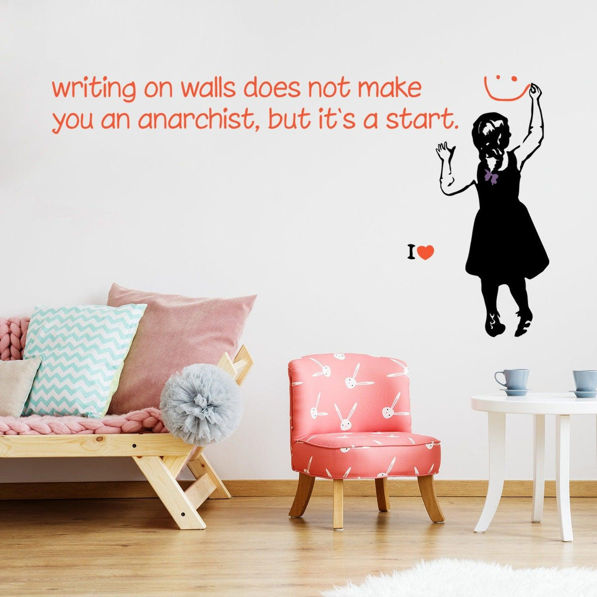 Banksy-style wall sticker with girl design and quote about anarchy, bright living room decor.