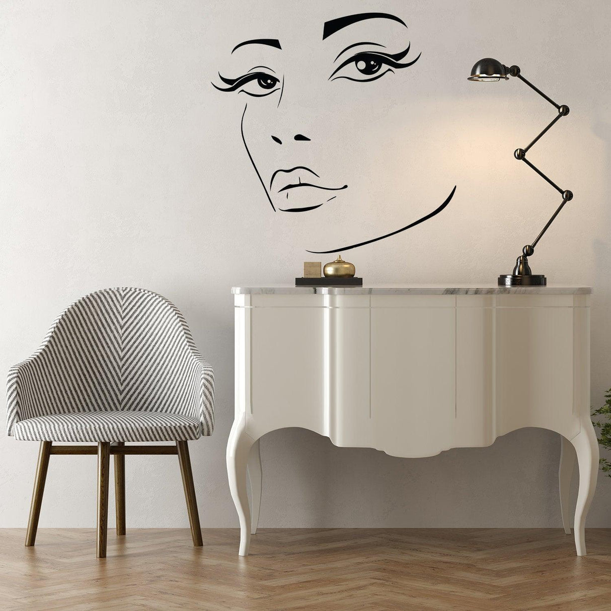 Elegant woman face vinyl wall sticker above a stylish chair and table, adding beauty to contemporary decor.