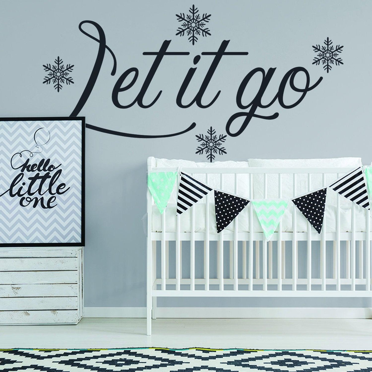 Let it go quote wall sticker with snowflakes in a stylish nursery decor setting.