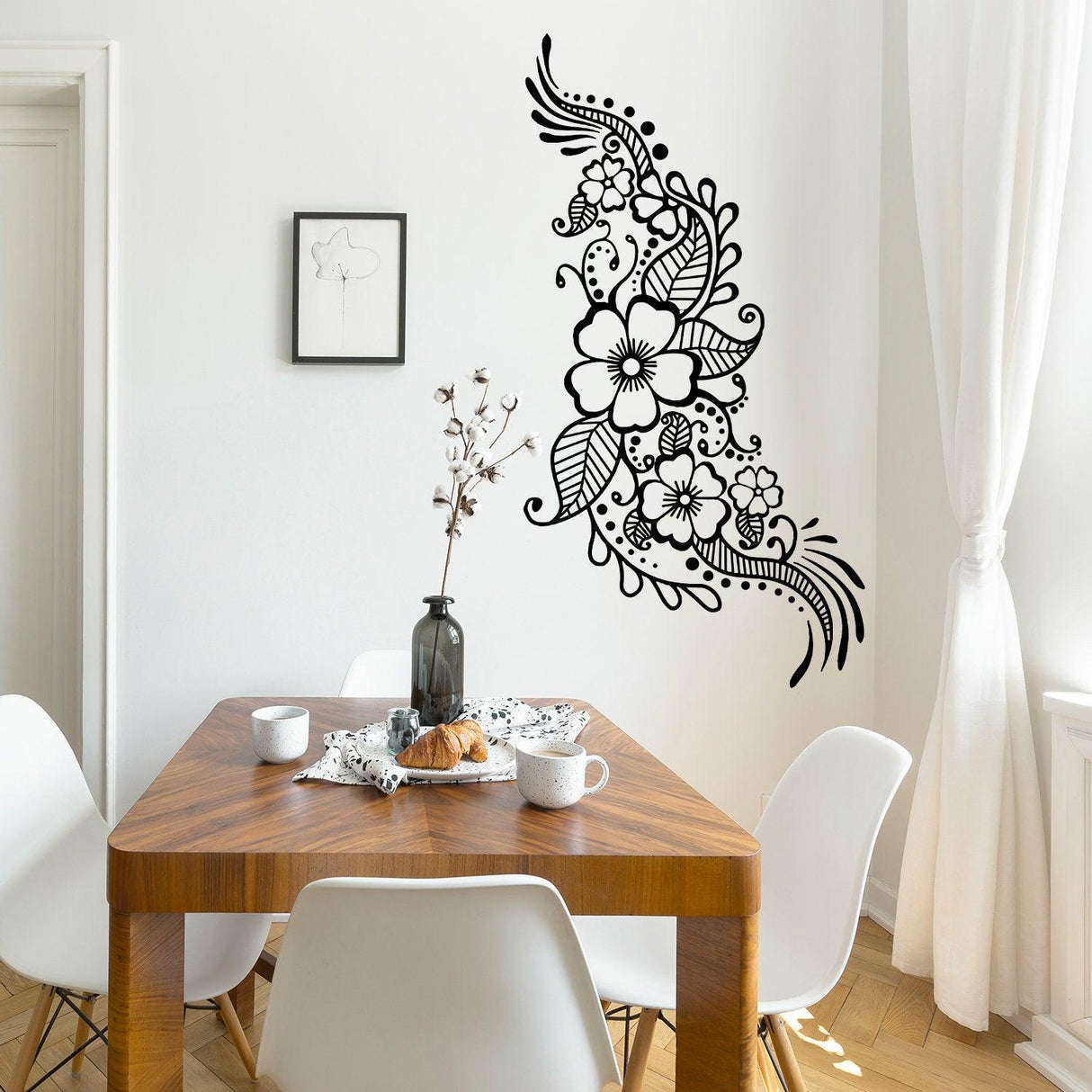 Henna tattoo wall vinyl sticker featuring floral mandala design in black on white wall near a wooden dining table.