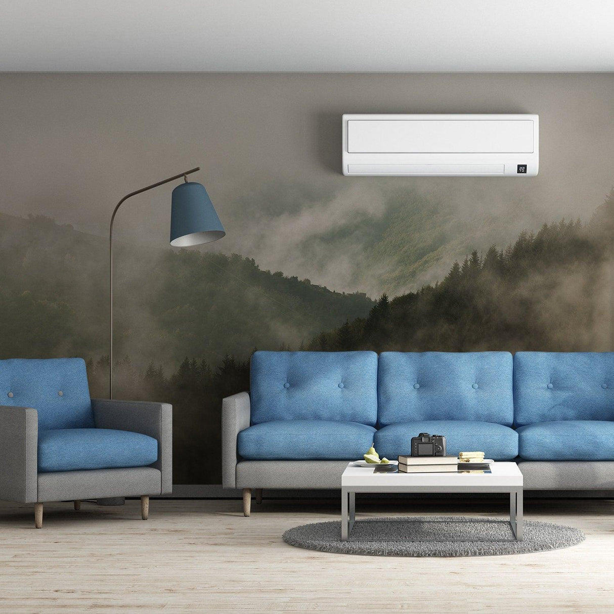 Foggy forest wallpaper mural in a living room with blue couches and modern decor, creating a serene atmosphere.