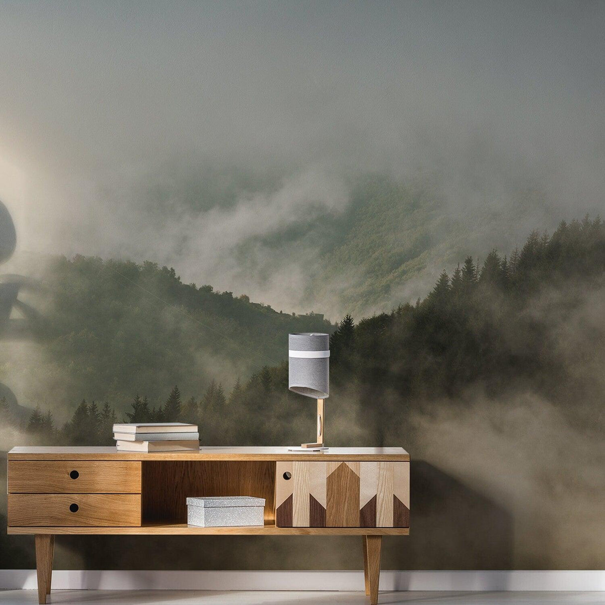 Foggy forest mural wallpaper featuring misty mountains and trees, enhancing room decor with a tranquil atmosphere.