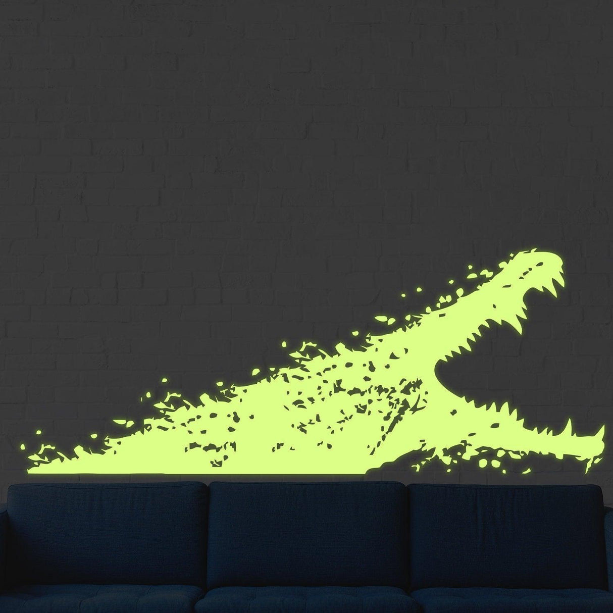 Glow in dark alligator wall sticker vinyl decal on a dark wall above a couch, adding nocturnal excitement to the room.