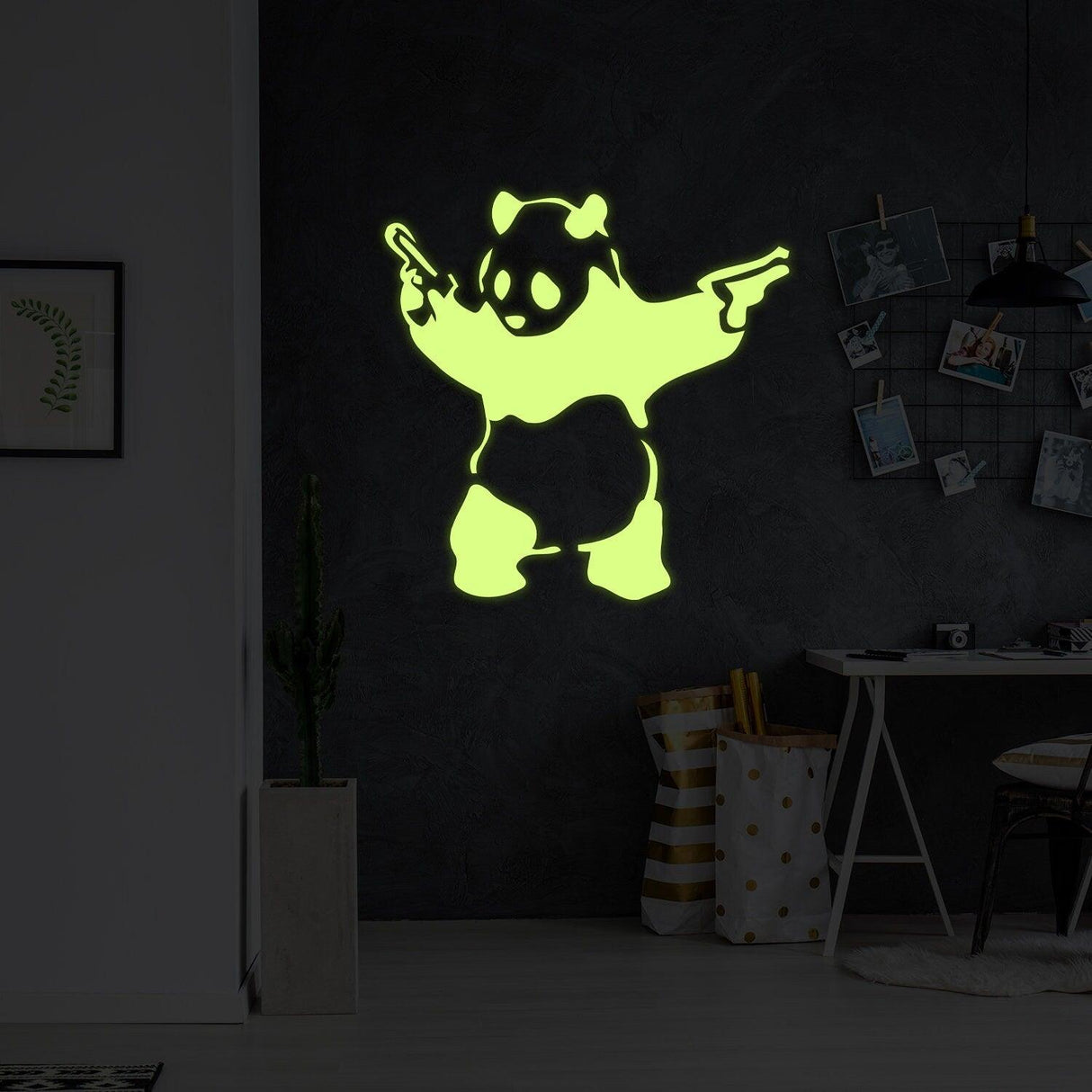 Glow in dark Banksy panda wall sticker design featuring a panda with guns on a dark wall.