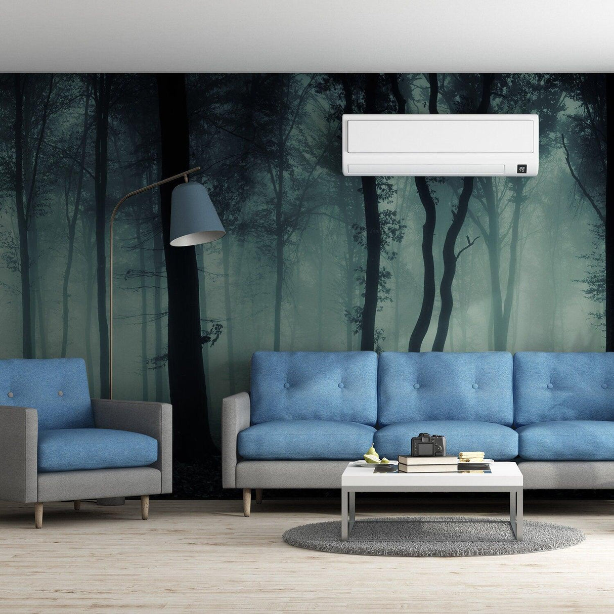 Foggy forest wallpaper mural in a modern living room with blue furniture and soft lighting.