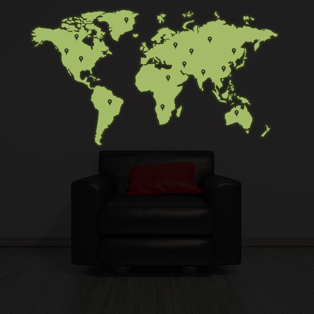 Glow in dark world map vinyl sticker on a dark wall above a chair, creating a striking home decor piece.