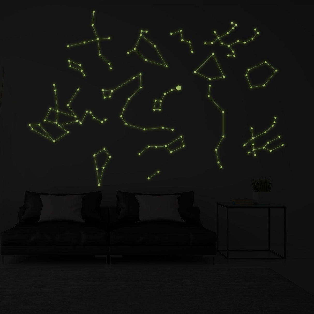 Glow in the dark ceiling decal featuring star constellations and lines on a dark wall above a modern sofa.
