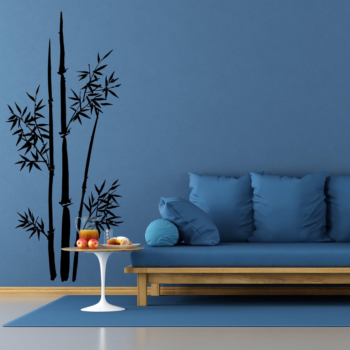Bamboo wall vinyl sticker art decor featuring elegant stalks against a blue wall with modern furniture in a living room setting.