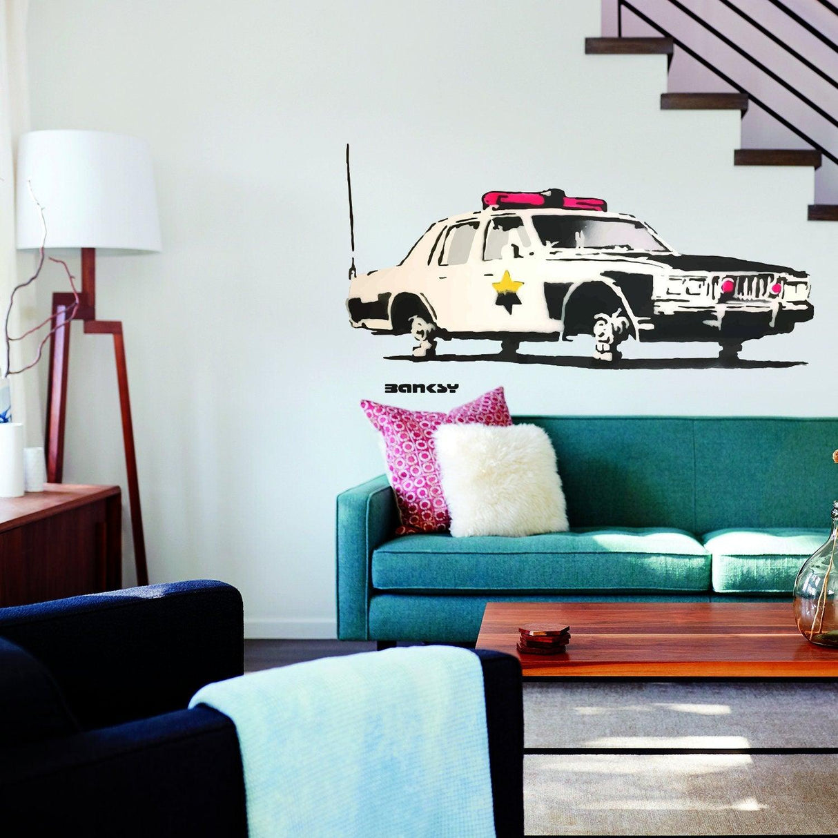Police car wall vinyl sticker displayed in a modern living room, adding a vibrant touch to home decor.
