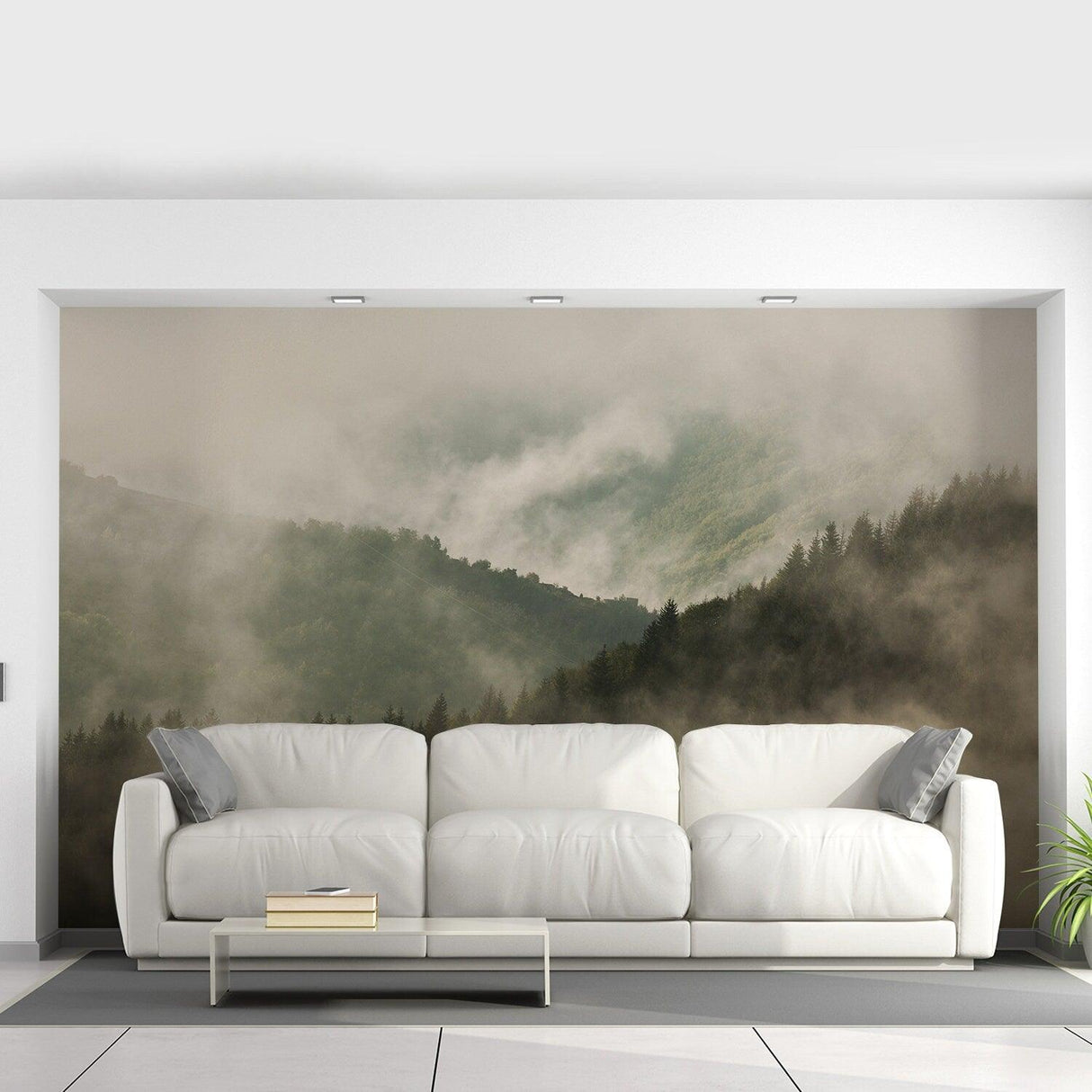 Foggy forest wallpaper mural featuring mountains and trees, creating a serene atmosphere in a modern living room.