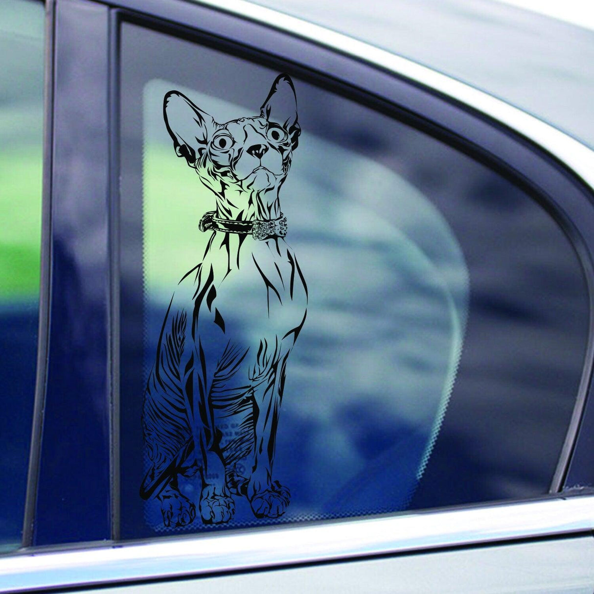 Custom cat vinyl decal on car window, showcasing a detailed design of a playful cat.