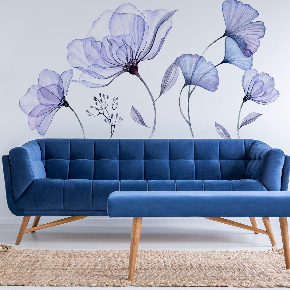 Stylish living room with a blue velvet sofa and stunning floral wall mural featuring delicate purple flowers.