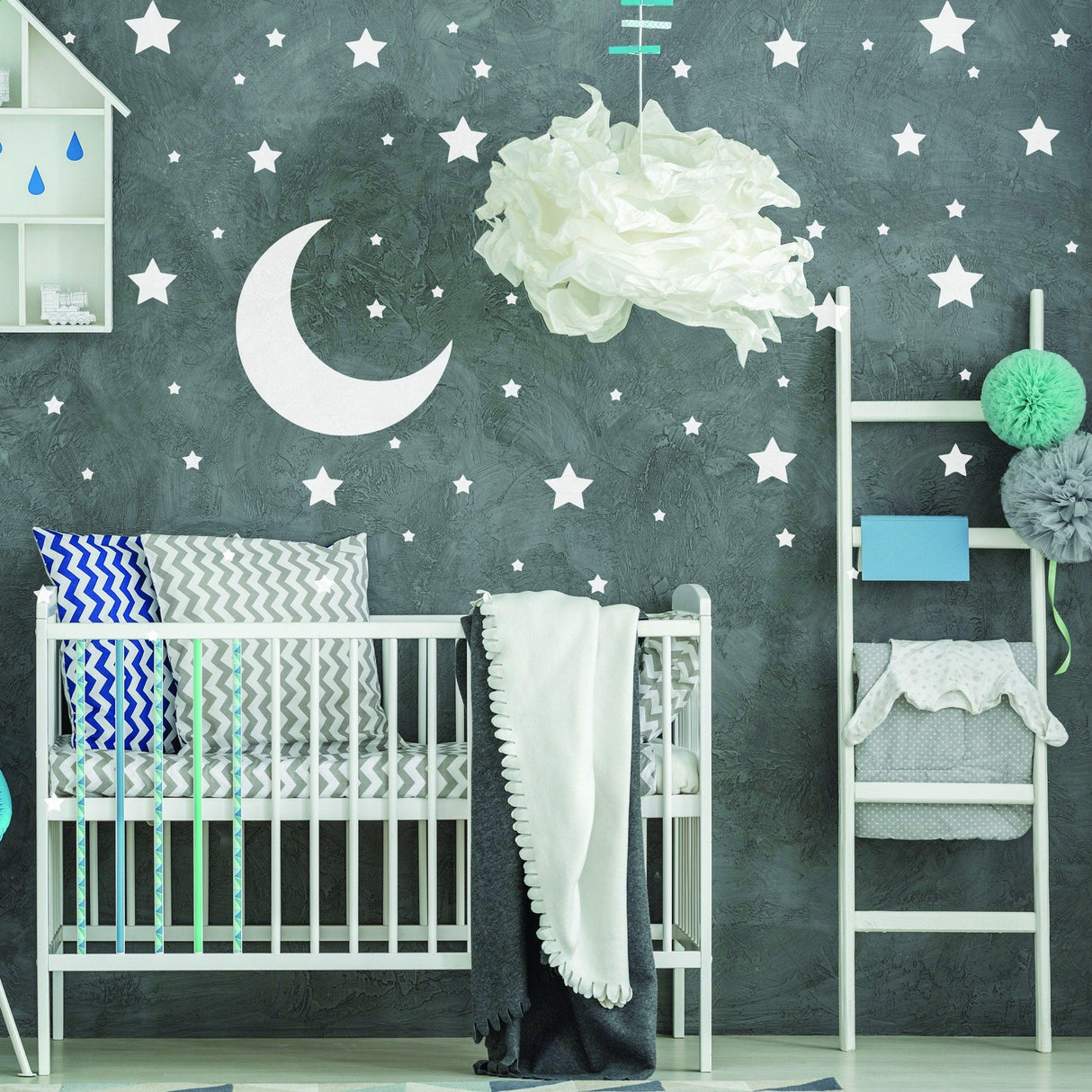 Whimsical nursery with 220x white star wall stickers and moon decor above a stylish crib.
