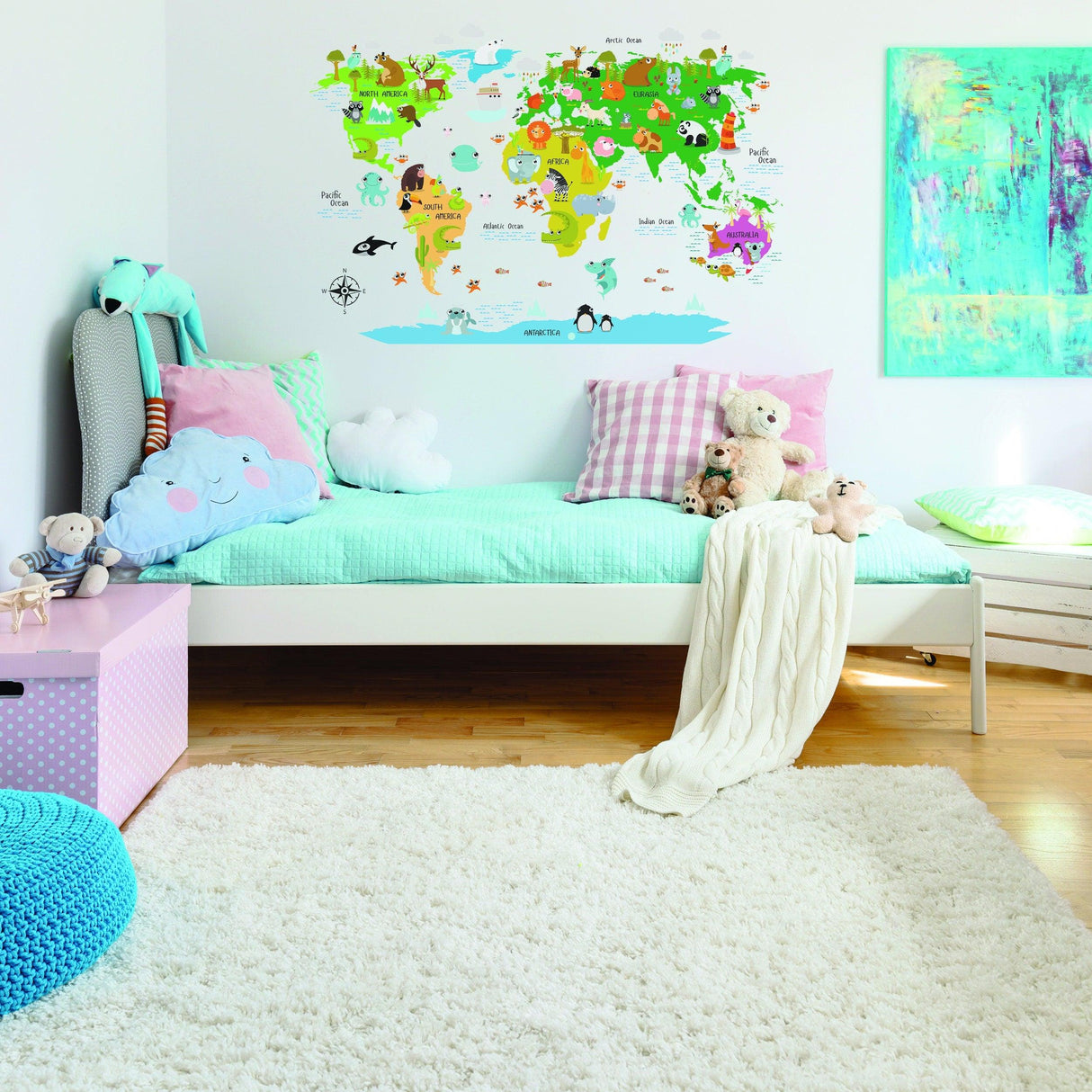 Colorful kids world map vinyl wall decal with animal illustrations in a cozy nursery setting.