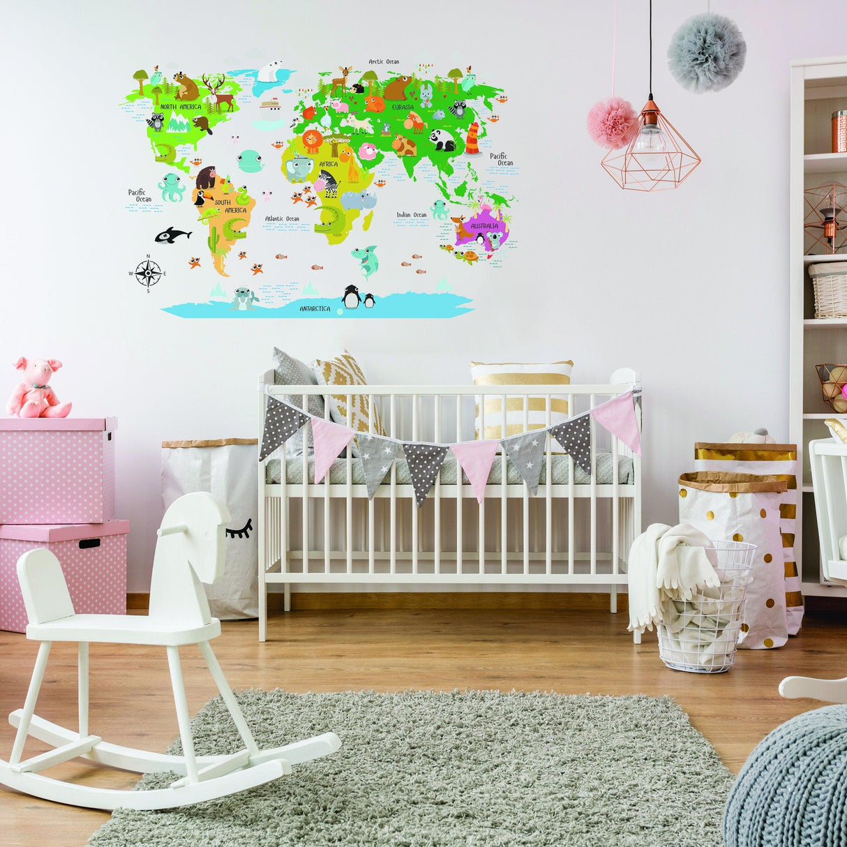 Colorful Kids World Map Wall Decal with animals, decorating a nursery above a crib and play area.
