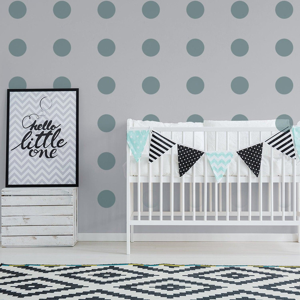 Nursery decor featuring circle wall decals, crib, and playful bunting in a stylish kids room.