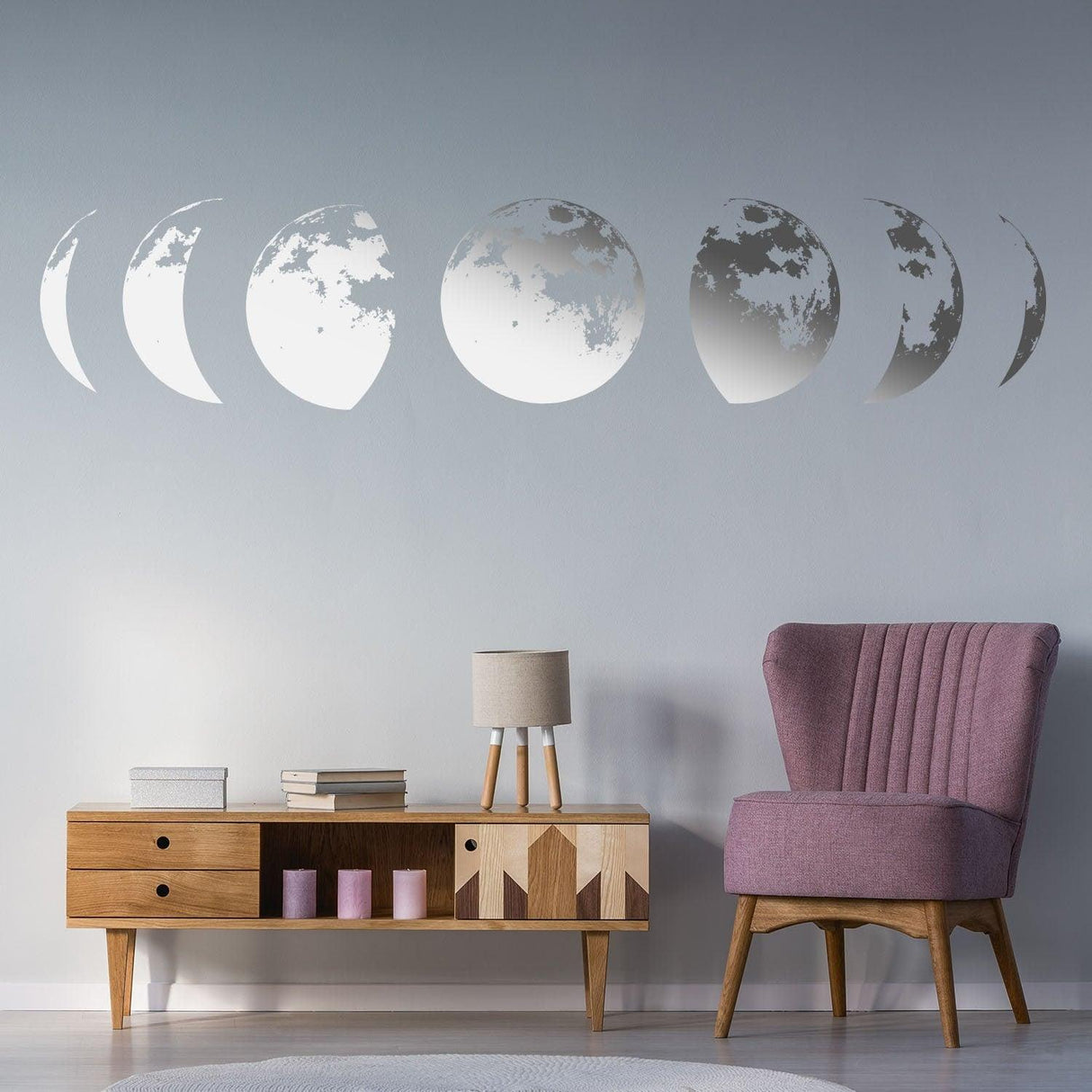 Moon phases wall decor decal in a stylish living room with pink chair and wooden TV stand.