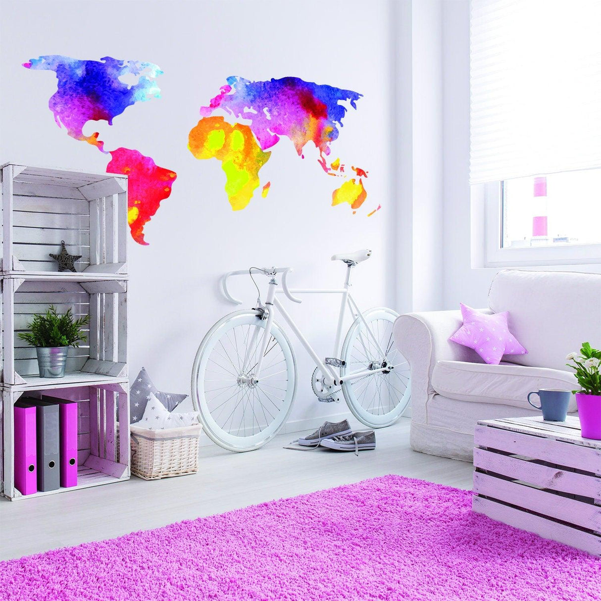 Colorful world map wall decal in a modern living room with a bicycle and vibrant decor.