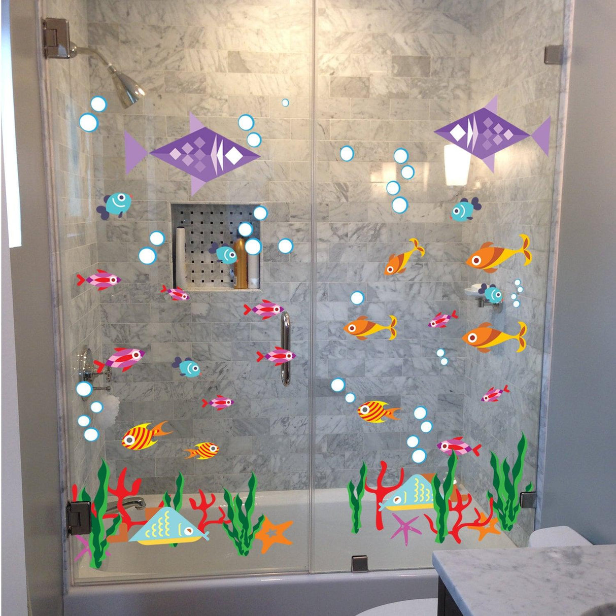 Colorful vinyl fish decals on a shower door, adding a fun and quirky ocean theme to bathroom decor.