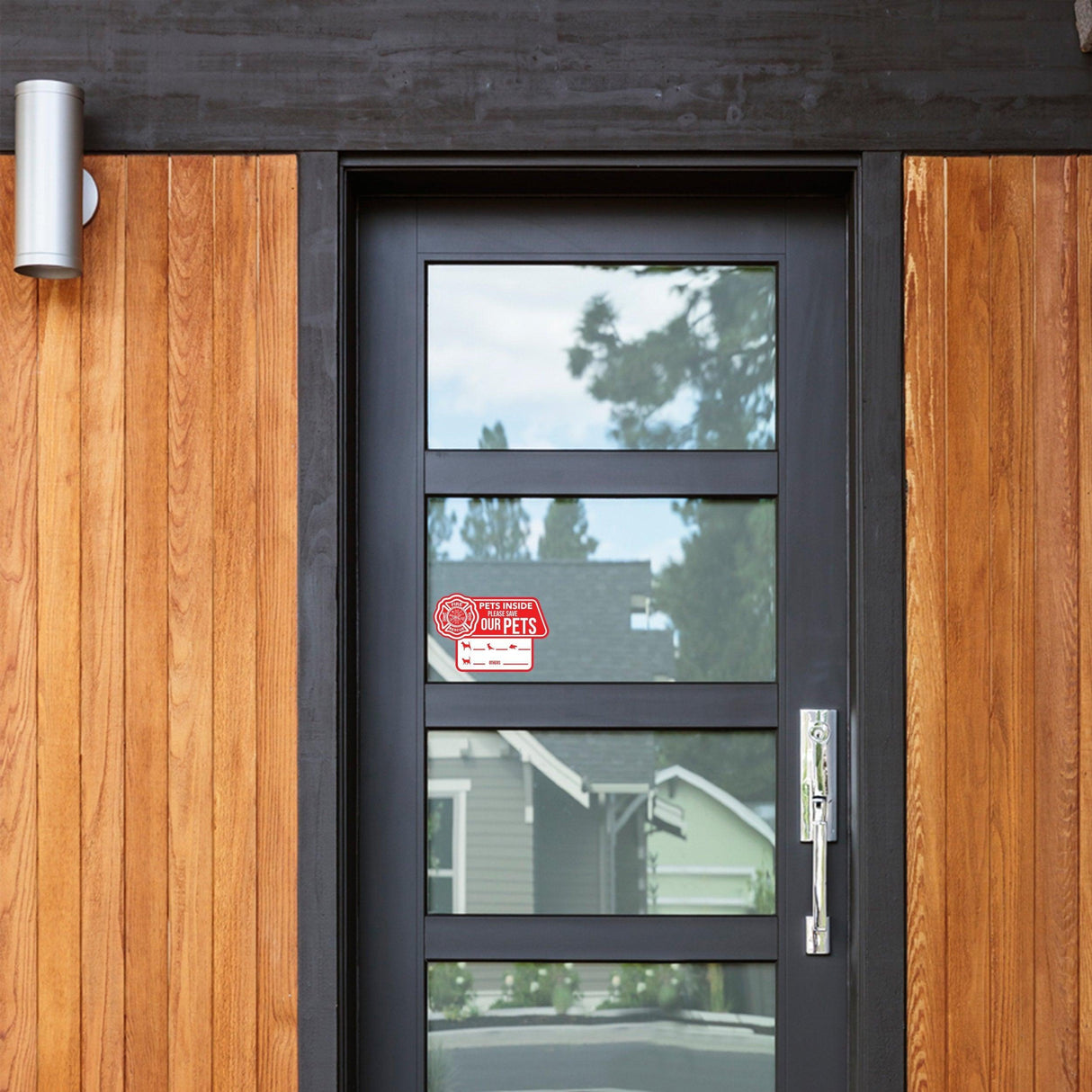 Home door featuring a 'We Love Our Pets' emergency cling sticker for pet safety.