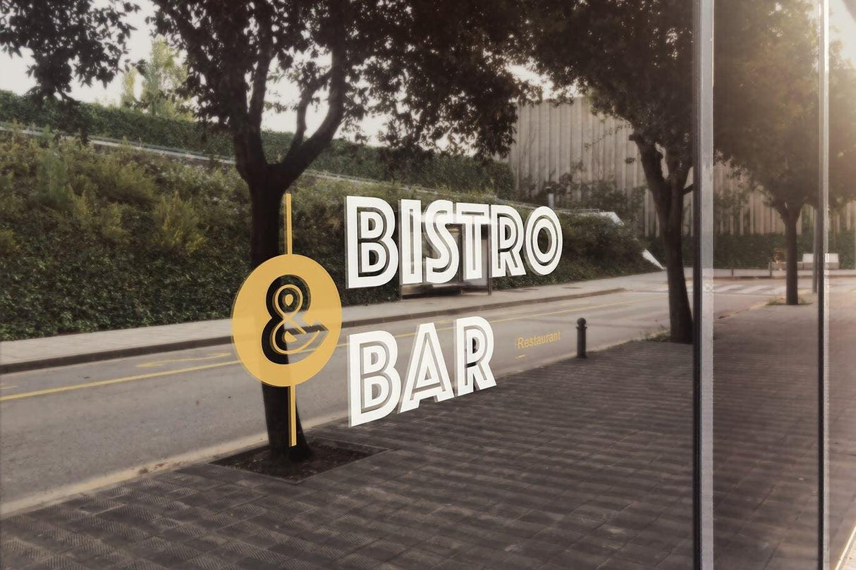 Window decal displaying 'Bistro & Bar' on a storefront with outdoor scenery.