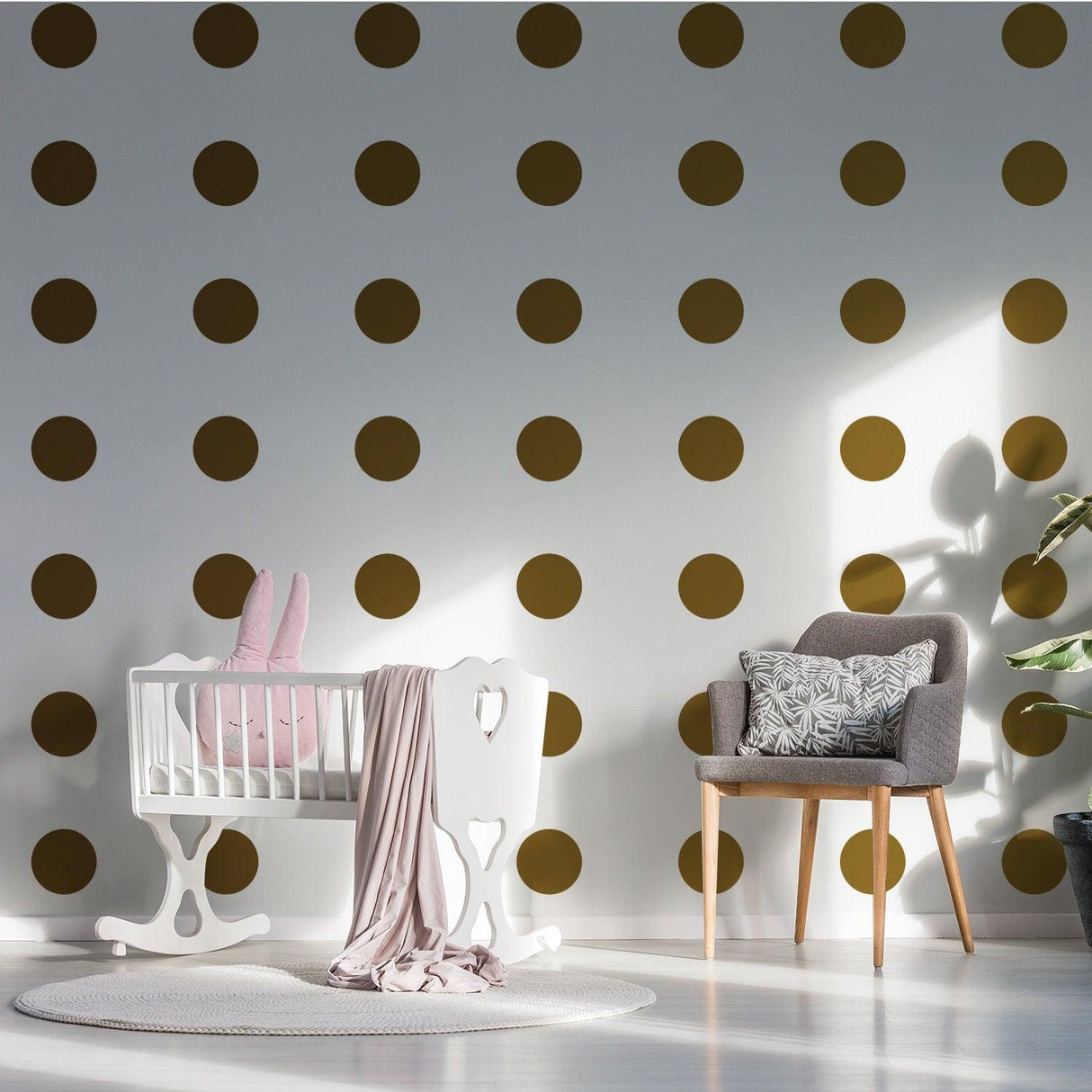 Elegant gold dot vinyl decals on nursery wall with crib and chair, perfect for kids room decor.