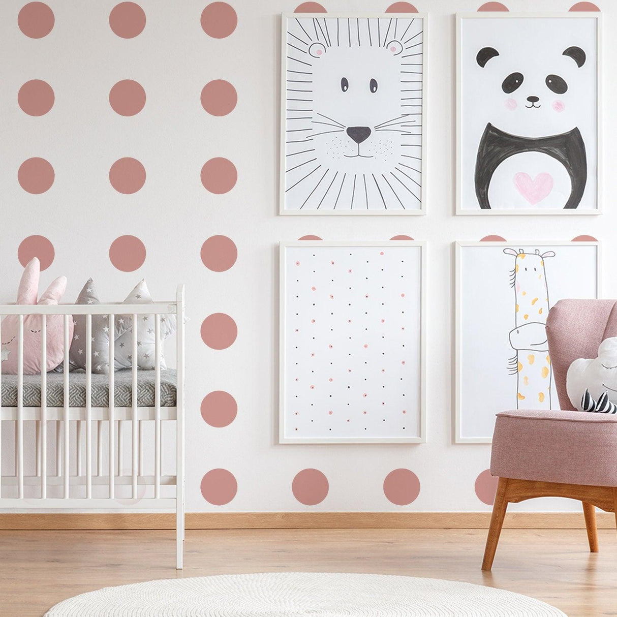 Cute nursery decor featuring pink circle wall decals and animal art prints for a stylish kids room.