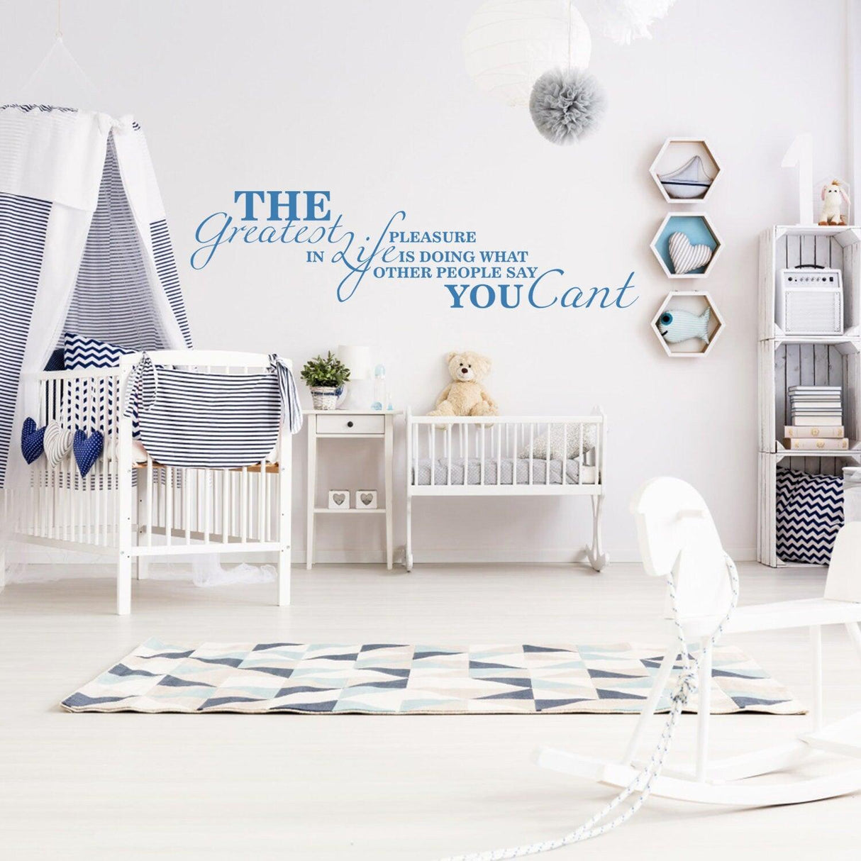 Wall quotes decal in a nursery, featuring inspiring saying about life and individuality in blue letters.