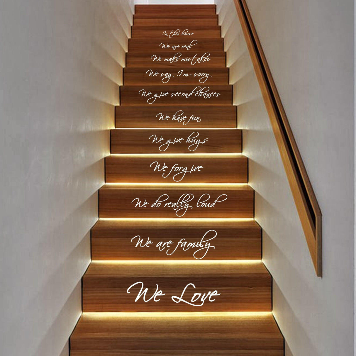 Staircase featuring inspirational vinyl quote decals about family, love, and forgiveness on wooden steps.