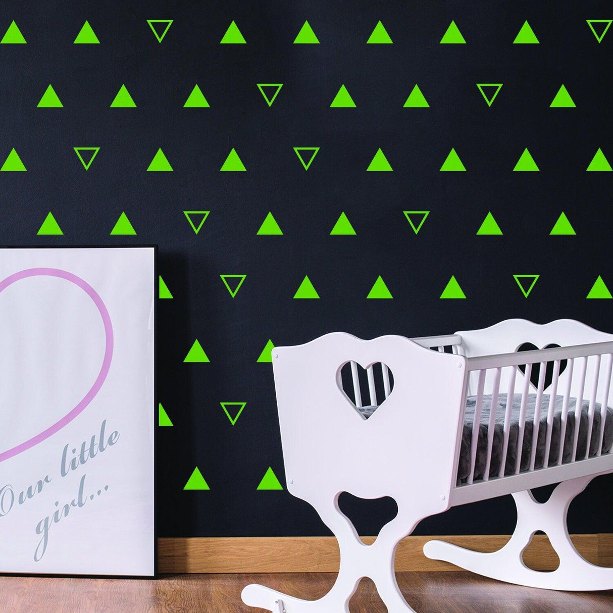 Triangle wall vinyl decals in vibrant green on a black nursery wall with a white crib and decor.