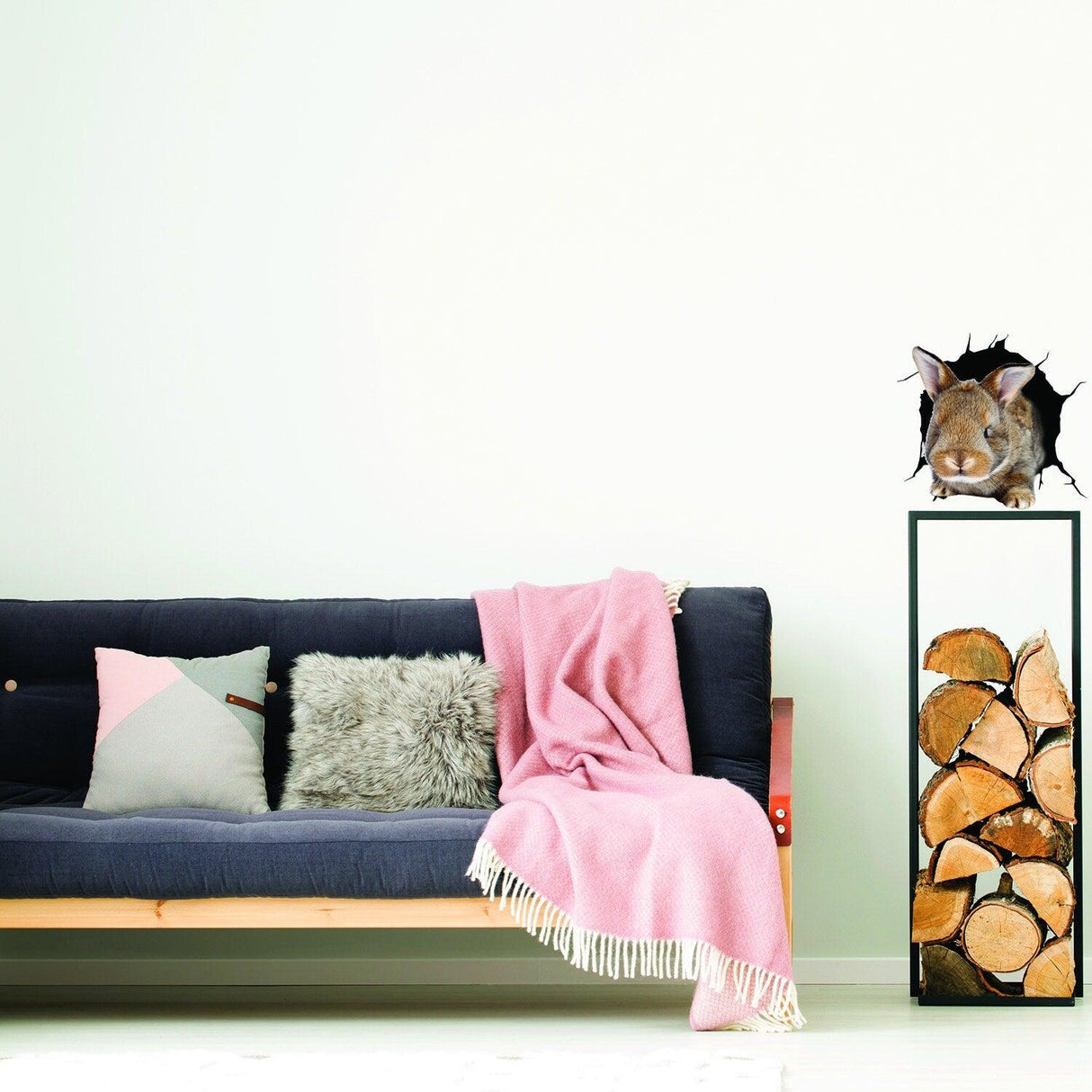 3D rabbit wall decal adding charm to a cozy living room with a sofa and pink throw.