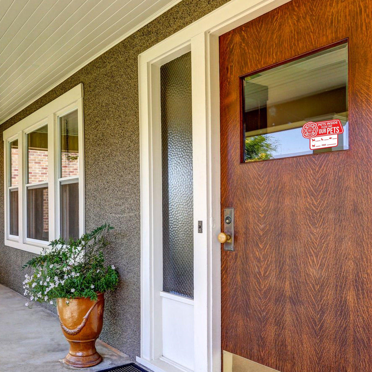Front door with a pet alert emergency cling sticker indicating pets inside for safety.