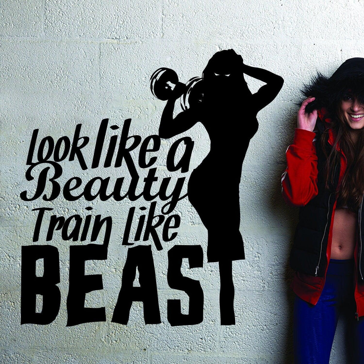 Fitness gym wall decal with motivational quote 'Look like a beauty, train like a beast' and woman lifting weights.
