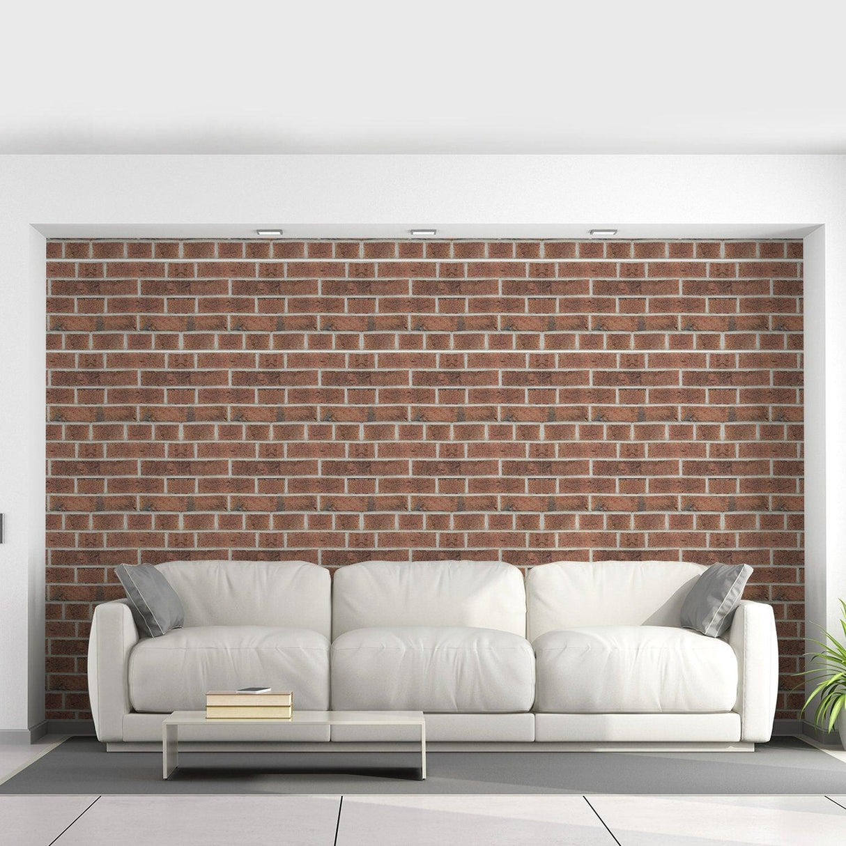 Living room featuring brick self-adhesive wallpaper with a 3D stone effect, complementing a stylish white sofa.