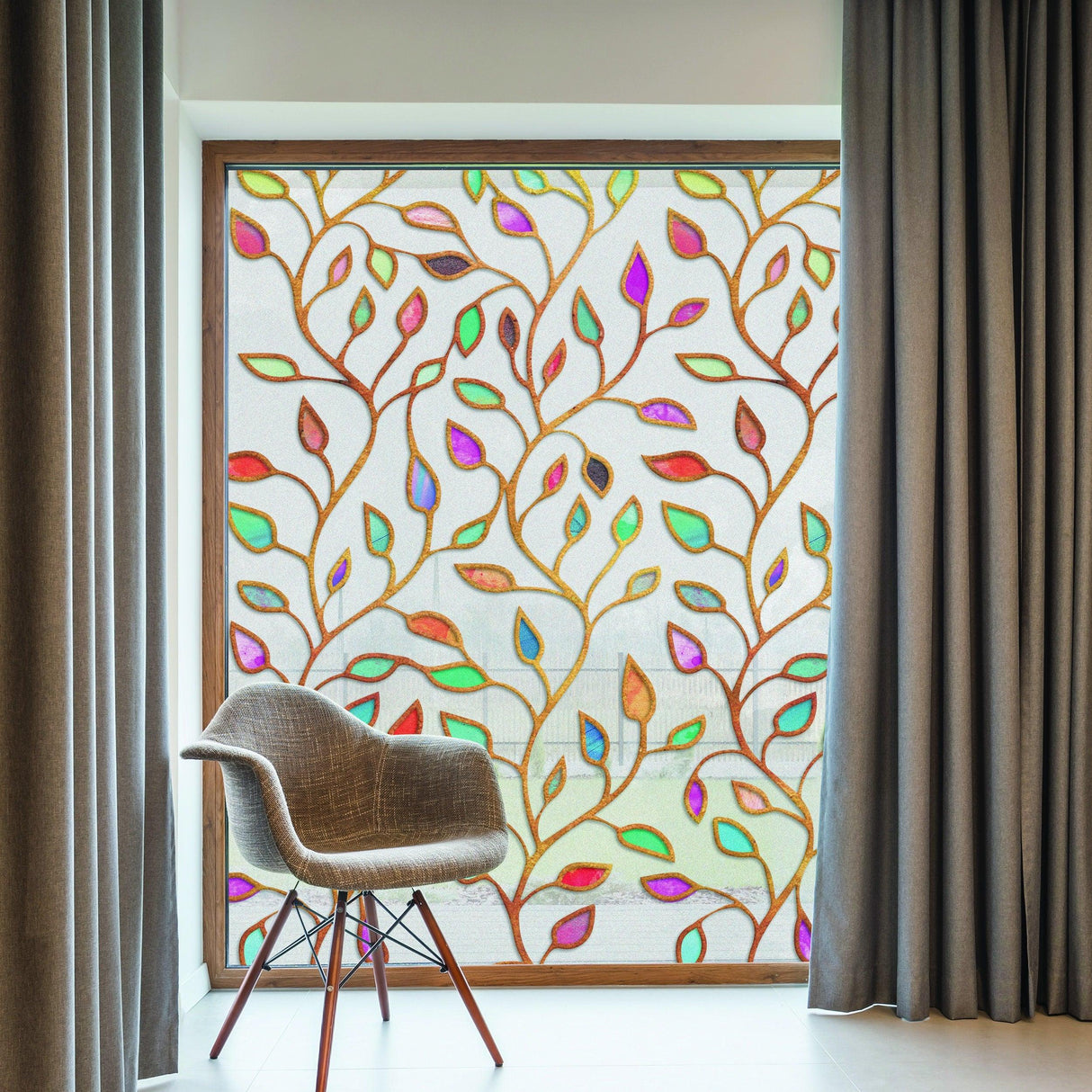 Frosted leaf window privacy film covering door with colorful leaf design and modern chair in a stylish interior.