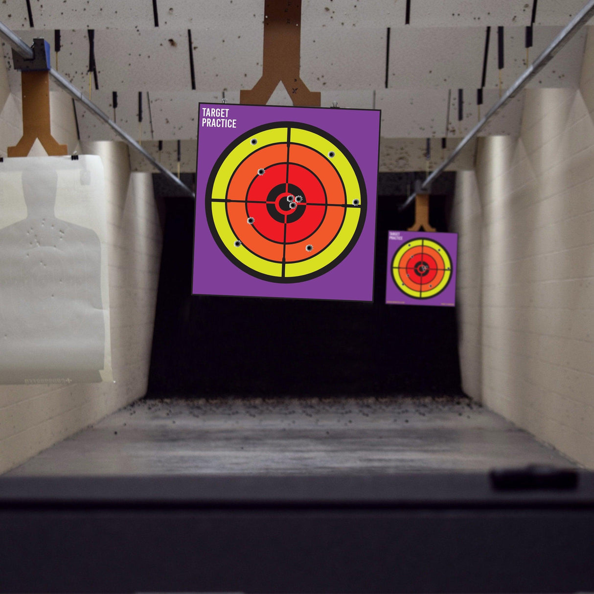 Indoor shooting range with large circle paper targets for gun practice and accuracy testing.
