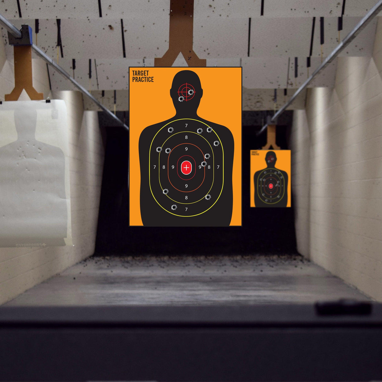 Indoor shooting range with large human silhouette targets for gun practice and training.