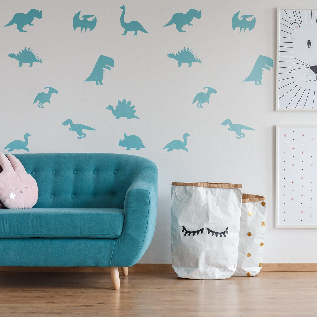 40x dinosaur silhouette wall decals in a baby nursery, featuring various dinosaur designs and a cozy teal couch.
