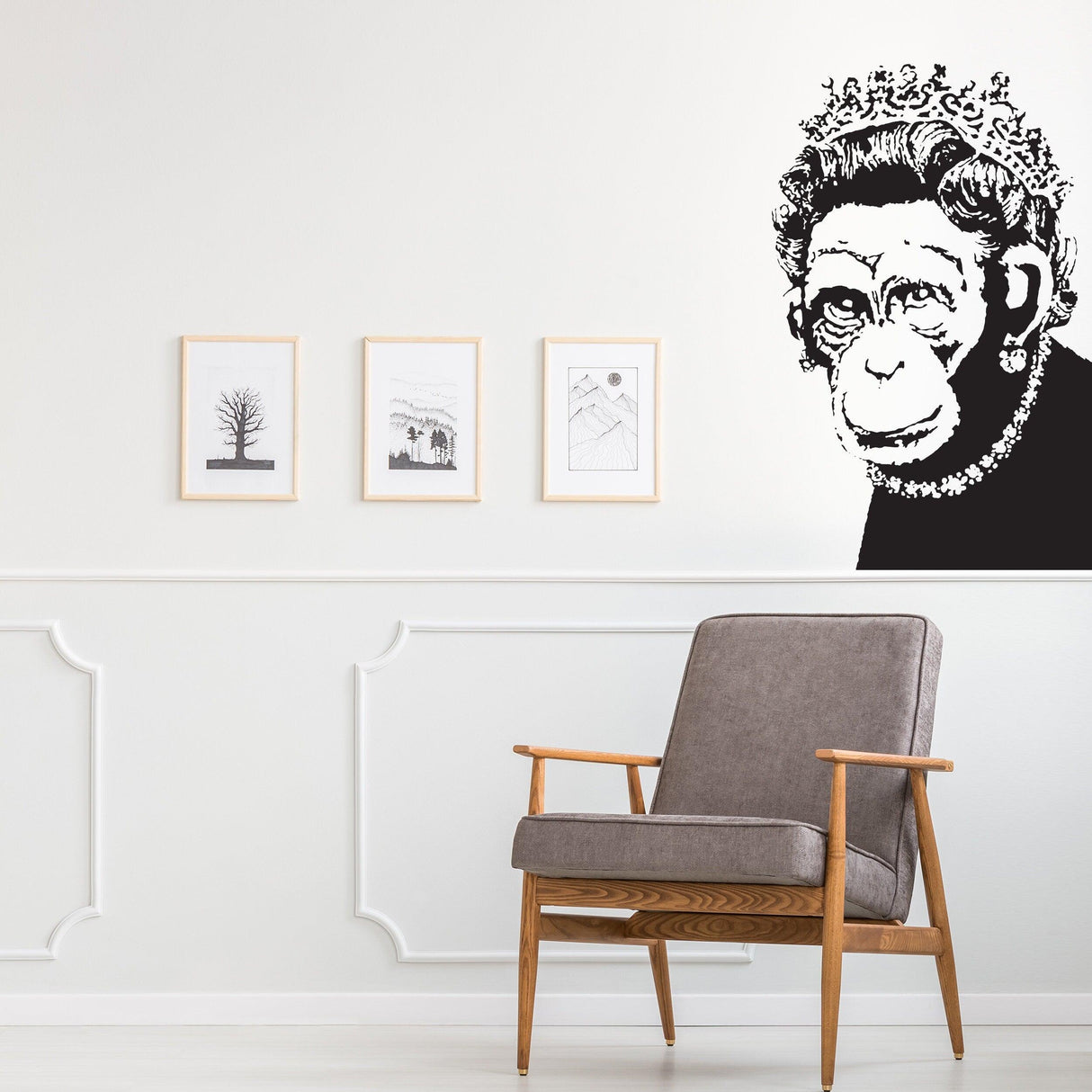 Banksy-inspired monkey queen wall art sticker in modern kitchen decor with framed prints and a stylish chair.