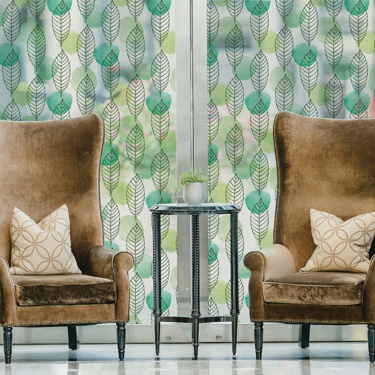 Leaf window privacy glass film with elegant design in a cozy living room setting with plush chairs.
